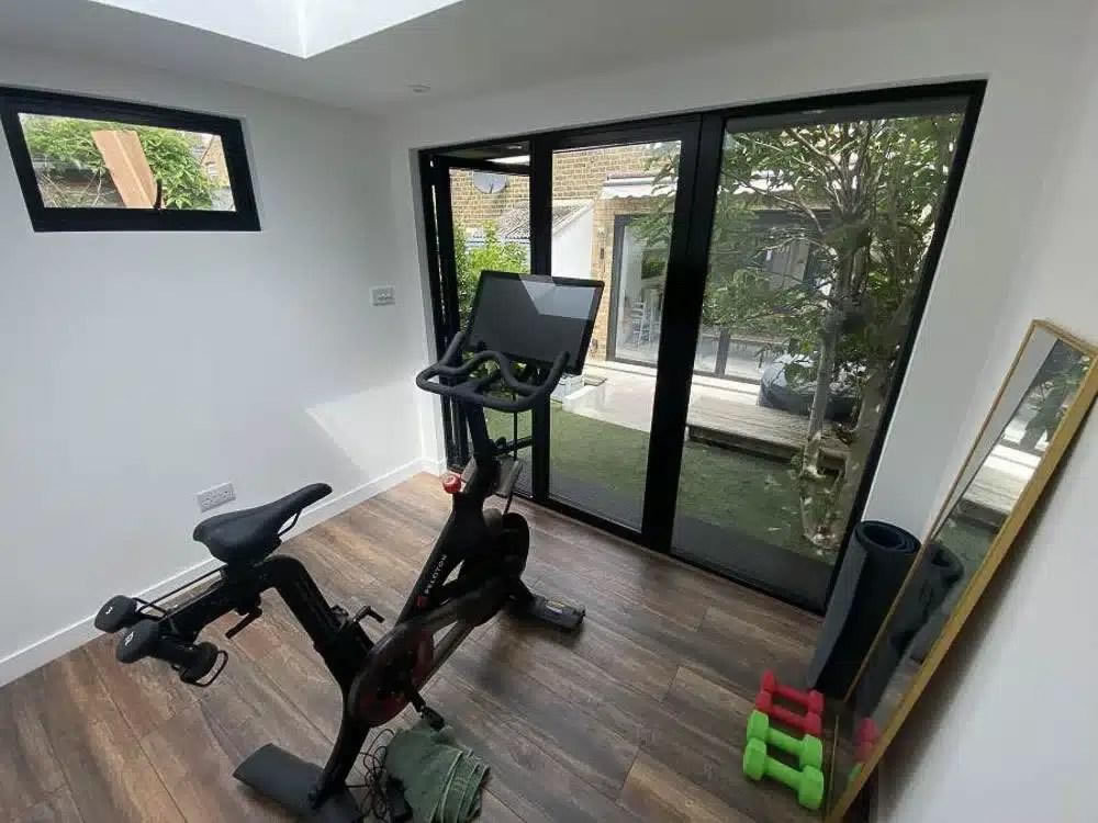 Compact home gym inside a timber garden building