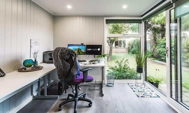 Modern garden office inside a corner log cabin
