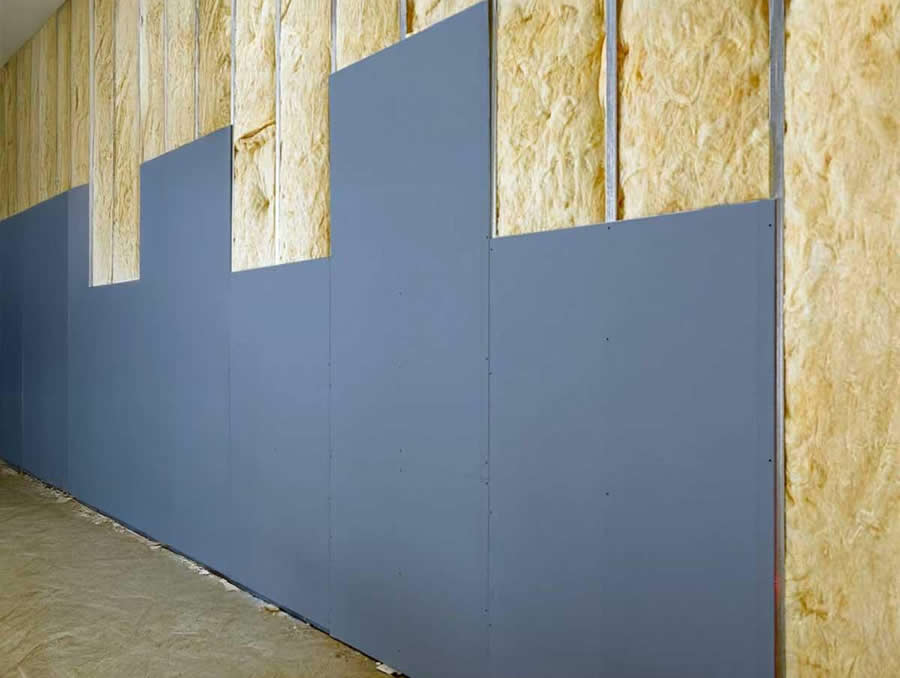 Independent timber stud wall installed against a partition