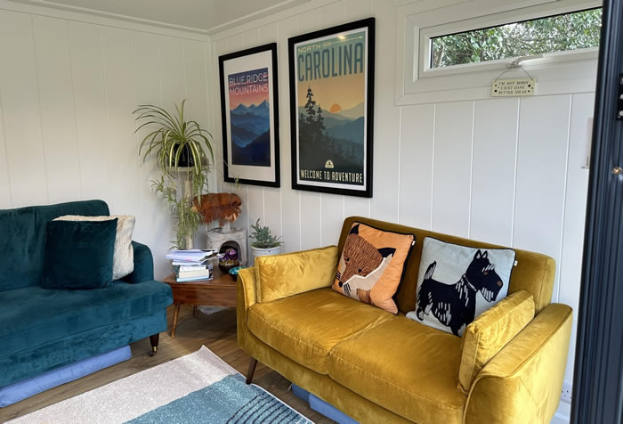 Corner sofa arrangement inside a garden cabin lounge
