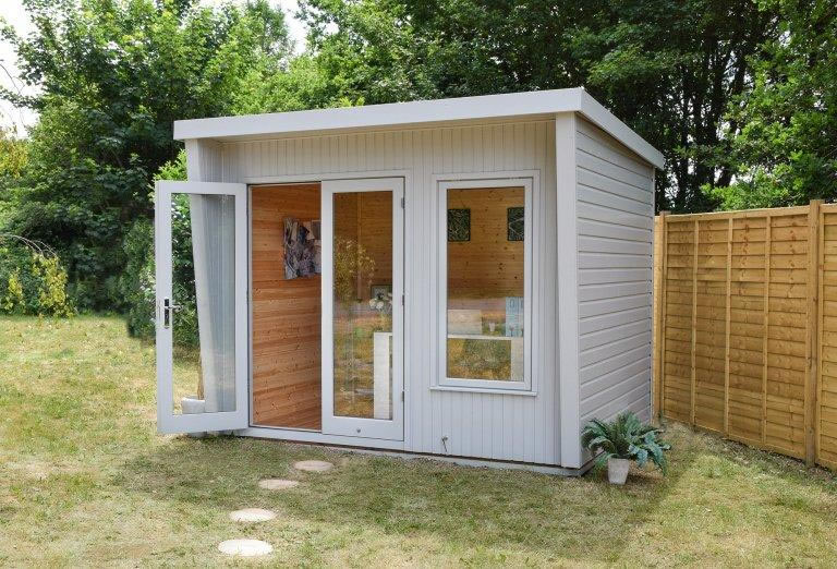 Small log cabin positioned near a boundary fence
