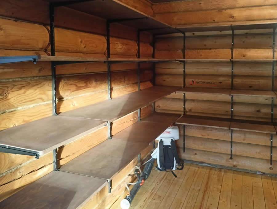 Wall-mounted shelving inside a timber storage room