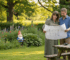 Couple reviewing garden cabin plans in garden