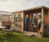 Family outside multi-room garden cabin England