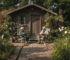 UK garden log cabin with couple relaxing