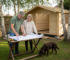 Couple reviewing log cabin plans in UK garden