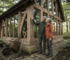 Timber frame cabin with couple outside in garden