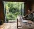 Man working in productive garden office cabin