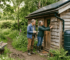 Couple with eco-friendly wooden garden cabin