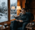 Man reading in heated garden cabin