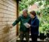 Couple inspecting garden cabin for waterproofing