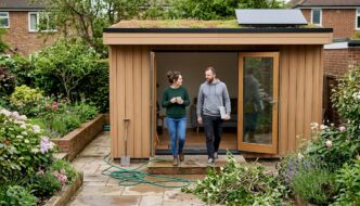 Modern UK garden cabin with owners outside