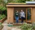 Modern UK garden cabin with owners outside