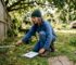 Person surveying garden site for cabin
