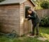 Homeowner checking lock on garden cabin