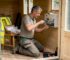 Electrician wiring inside a wooden garden cabin