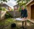Homeowner reviewing construction of garden building